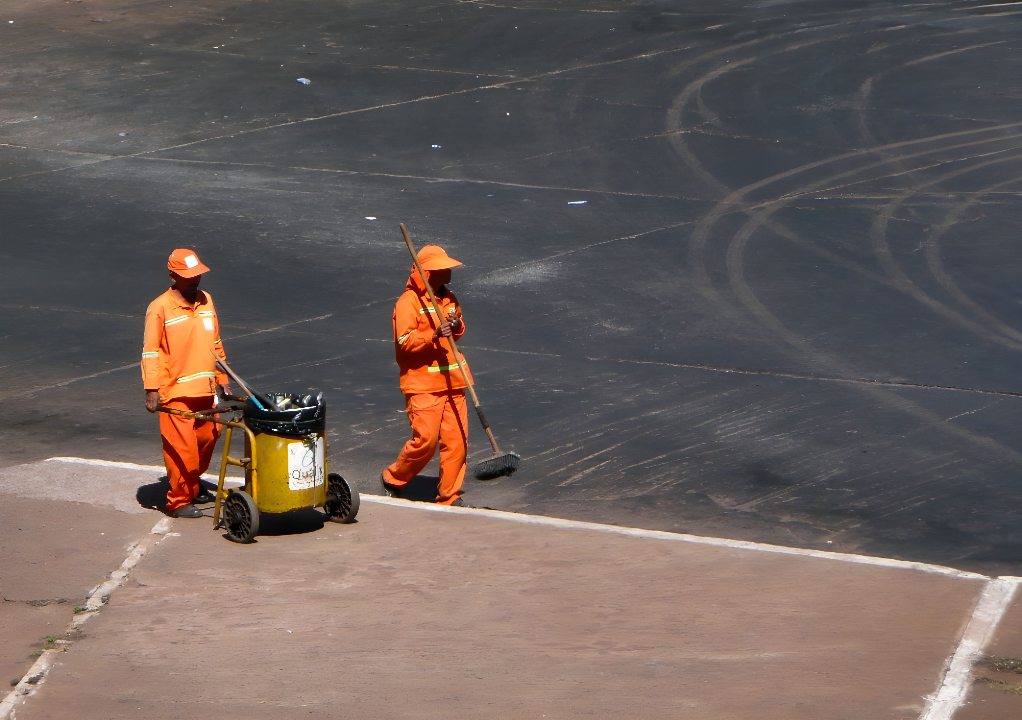 Sweeping crew on a paved yard